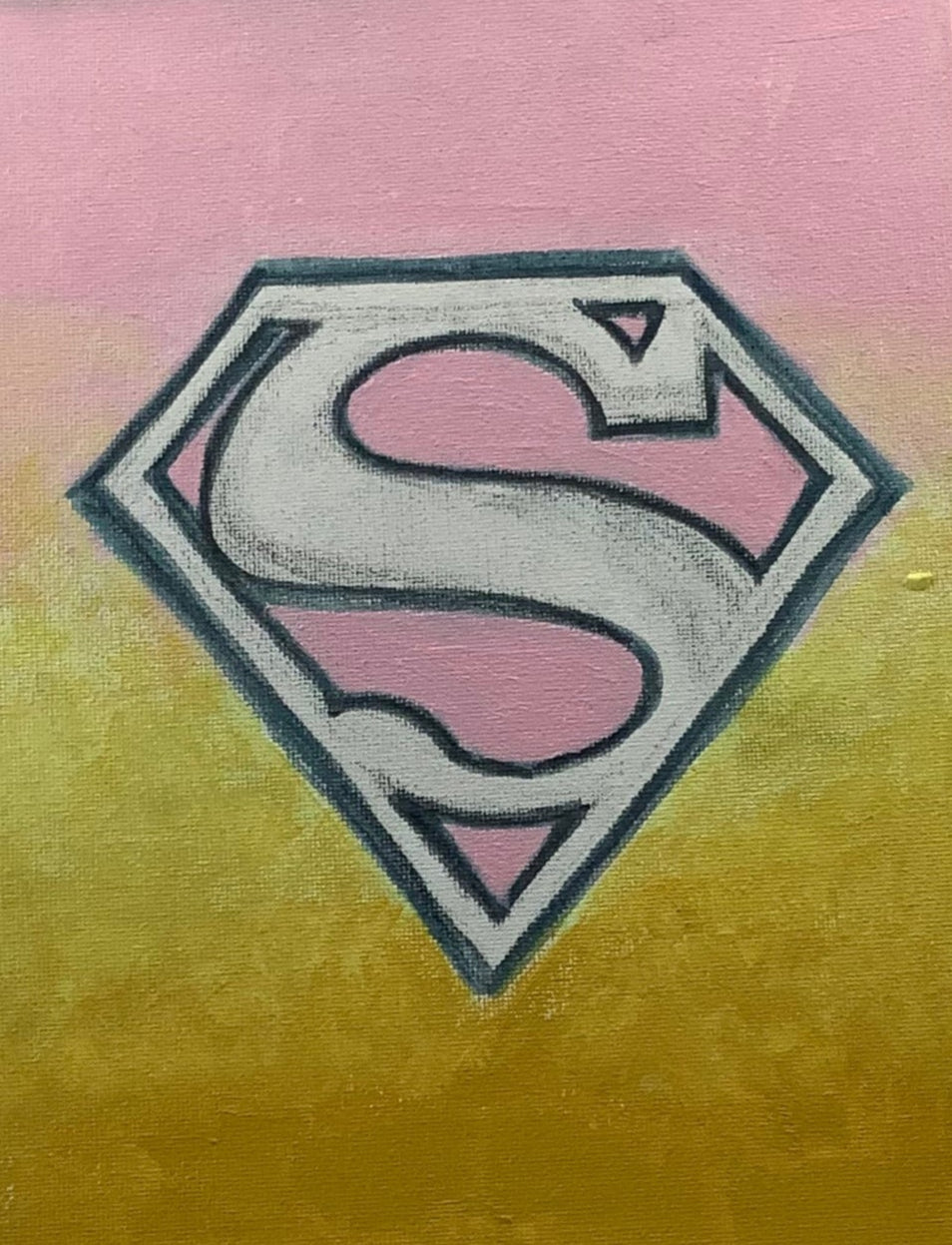 Canvas with a logo on an easel against a white wall